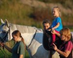 Більше трьох сотень дітей пройшли в Житомирі курс іпотерапії. житомир, лікування, інвалід, інвалідність, іпотерапія, person, outdoor, child, boy, young, little, animal, clothing, horse, crowd. A young boy standing next to a horse