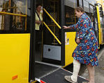 На програму перевезення людей з інвалідністю виділено 30 млн грн. андрій рева, доступність, перевезення, транспорт, інвалідність, person, indoor, clothing, standing, bus, yellow. A person standing in front of a bus
