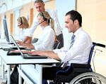 Надання послуг особам з інвалідністю. безробітний, вакансія, профорієнтація, центр зайнятості, інвалідність, person, computer, indoor, man, laptop, clothing. A person sitting at a desk with a laptop