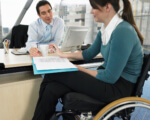 Що треба знати при прийомі на роботу працівників з інвалідністю. Нотатка для роботодавця. іпр, працевлаштування, працівник, роботодавець, інвалідність, person, woman, clothing, indoor, computer. A woman sitting at a table